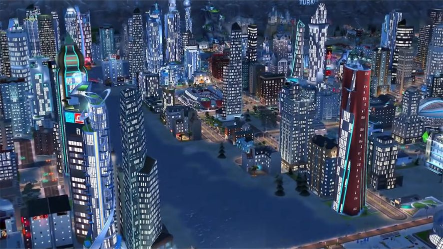 SimCity Buildit in-game screenshot showing a city at night from a bird's eye view.